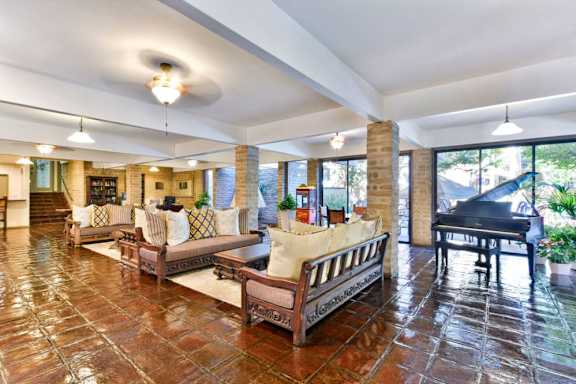 a large living room with furniture and a piano