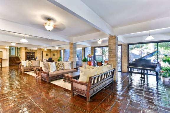 a large living room with furniture and a piano