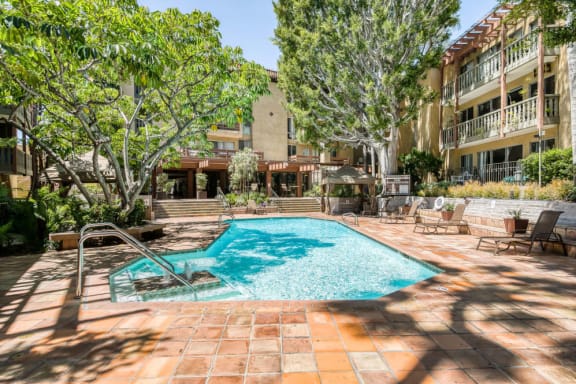 a swimming pool in front of an apartment building