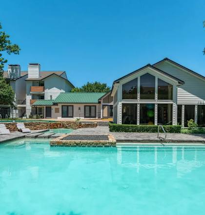 A swimming pool in front of a house.