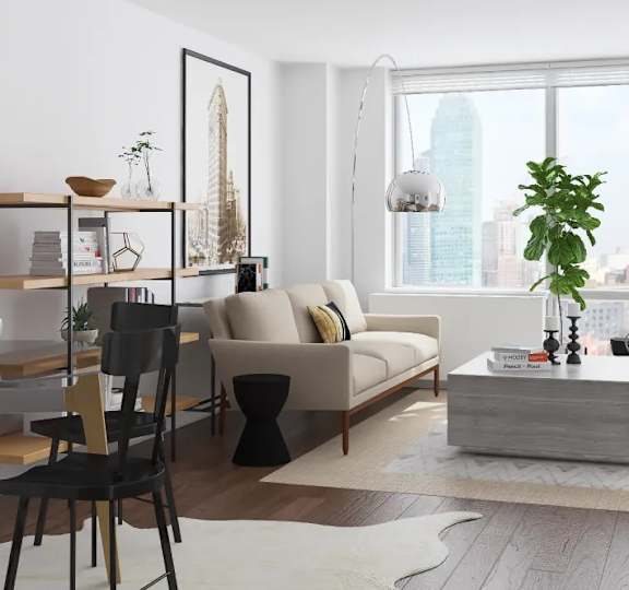 A modern living room with a large window overlooking a cityscape at The Maximilian Apartments, Long Island City, NY