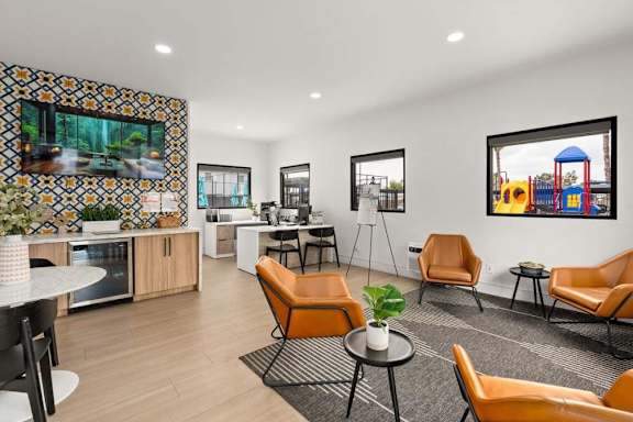 A modern living room with a kitchen area in the background.