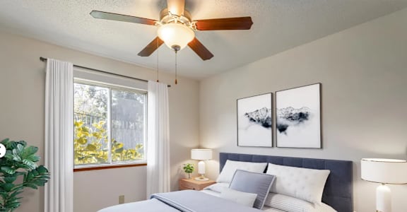 an empty bedroom with a bed and a ceiling fan