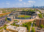Thumbnail 45 of 59 - A large stadium with a green field in the center and a city skyline in the background.
