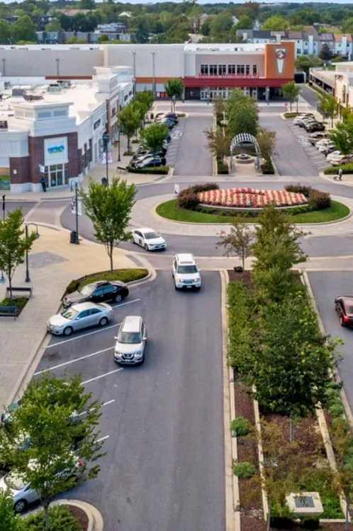an aerial view of a city street with cars and buildings