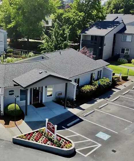 A sign for Briar Creek Apartments is surrounded by flowers.
