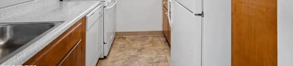 Rich wood cabinets and a gas stove