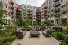 Outdoor courtyard with couches and a fire pit at Highgate At The Mile in McLean, Virginia 22102