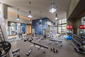 Workout room with weights and other exercise equipment at  Highgate At The Mile Apartments in McLean