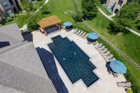 Aerial view of pool with lounge chairs at alvista harmony apartments