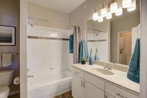Bathroom with vanity sink area with light on for apartment building