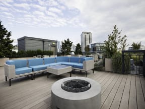 Relaxing roof top garden with lounge seating and firepit from a different angle