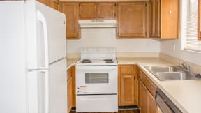 Kitchen with fridge stove at Laurel Grove Apartment Homes, Orange Park, Florida