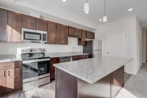 Kitchen Featuring Granite Countertops & Stainless Steel Appliances