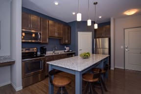 Spacious Kitchen with Stainless Steel Appliances and Granite Countertops