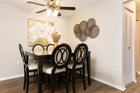 Spacious Dining Room with Ceiling Fan and Light and Hardwood Style Flooring