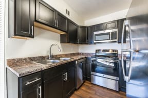 Kitchen with stainless steel appliances at Metro Tucson Apartments