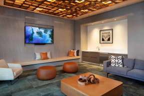 Relaxing Media Room with Ample Seating Opportunities, Flat Screen TV, and Intricate Ceiling Styling at North+Vine in Chicago