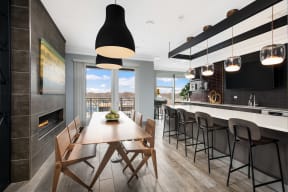 a dining area with a wooden table and chairs and a large window with a view of the