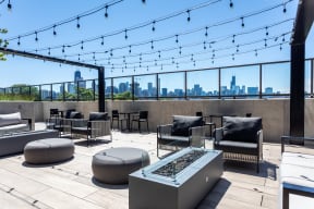 a rooftop lounge with a view of the chicago skyline