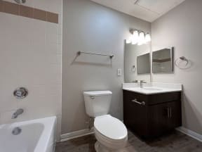 Renovated floorplans feature dark bathroom cabinetry with new countertops and fixtures.
