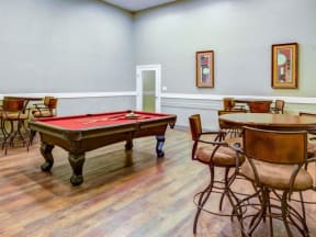Game room with pool table and high-top table seating