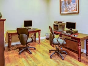Business center with desk style seating and computers