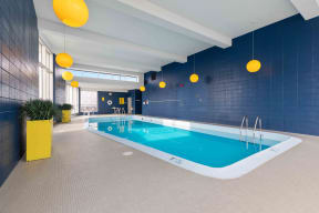 Wave Lakeview Apartments Indoor, Heated Swimming Pool with Decor and Large Windows Providing Chicago Skyline Views
