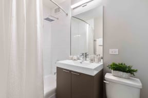 Wave Lakeview Apartments Bathroom with Stylish Fixtures, Shower Tub, and Modern Vanity with Storage