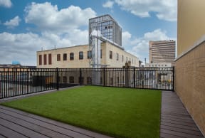 a small astroturf lawn on the roof of a building