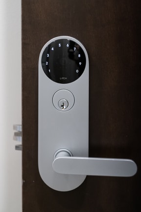 a white door handle with a small screen on it