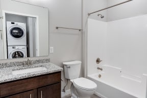 a bathroom with a washer and dryer in it