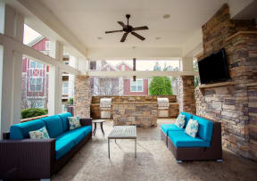 outdoor lounge with seating tv and grills