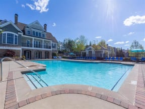 pool with sundeck and patio seating