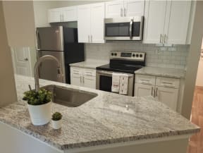 Renovated kitchen with granite at The Orleans of Decatur, Decatur