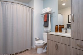 The Byway | Model #105 Bathroom Boasts Plenty of Storage and Curved Shower Rod