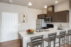Apartments for Rent in Corvallis, OR - The Quad - OSU Kitchen with stainless steel appliances and modern wood cabinets
