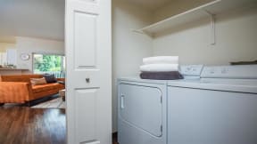 Village at Main Street | Laundry Area with Full Size Washer and Dryer and Shelving