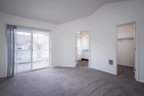 Village at Main Street | 2x2 Bedroom Spacious Bedroom with Wall to Wall Cabinetry and Patio Access
