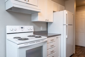 The Crossings | Kitchen with white cabinetry and white appliance package
