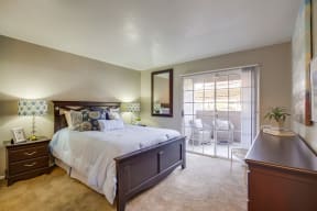Vista Promenade Apartments in Temecula - Bedroom with Stylish Decor, Wall to Wall Carpet, Beige Walls, and Access to Patio/Balcony