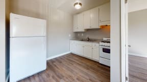 Apartments in Colton CA - Las Brisas One Bedroom Apartment Kitchen with White Appliances and White Cabinets