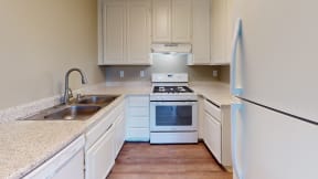 Apartments in Ontario for Rent - Avante Apartments Kitchen with White Appliances, White Cabinets, and Granite Countertops