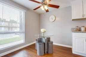 Apartments for Rent in West Covina - Tuscany Villas Kitchen with White Custom Cabinetry, Hardwood Flooring, White Appliances, and Grey Walls