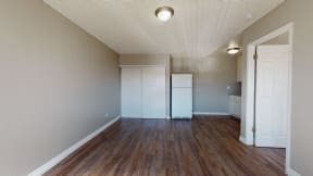 Colton CA Apartments for Rent - Las Brisas Apartment Living Room with Hardwood Flooring, Closet, and Access to Kitchen