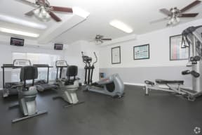 West Covina, CA Apartments - Tuscany Villas Fitness Center with Elliptical, Treadmills, Ceiling Fans, Large Window, and More