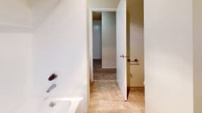 Apartments Ontario - Encore Apartment Homes - Bathroom with a Bathtub and Tile Flooring