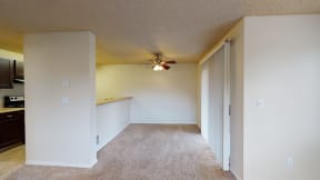Pet-Friendly Apartments in Ontario CA - Encore Apartment Homes - Open-Concept Dining Area with Carpet Flooring and a Ceiling Fan Next to the Kitchen