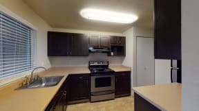 Apartments in Ontario for Rent - Kitchen with Wood Cabinets, Stainless Steel Appliances, and Pantry