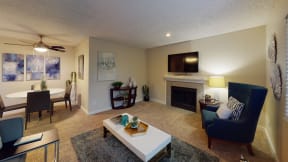 Ontario CA Apartments - Encore Apartment Homes - Living Room with Wall to Wall Carpet, Fireplace, Stylish Decor, and Access to Dining Room